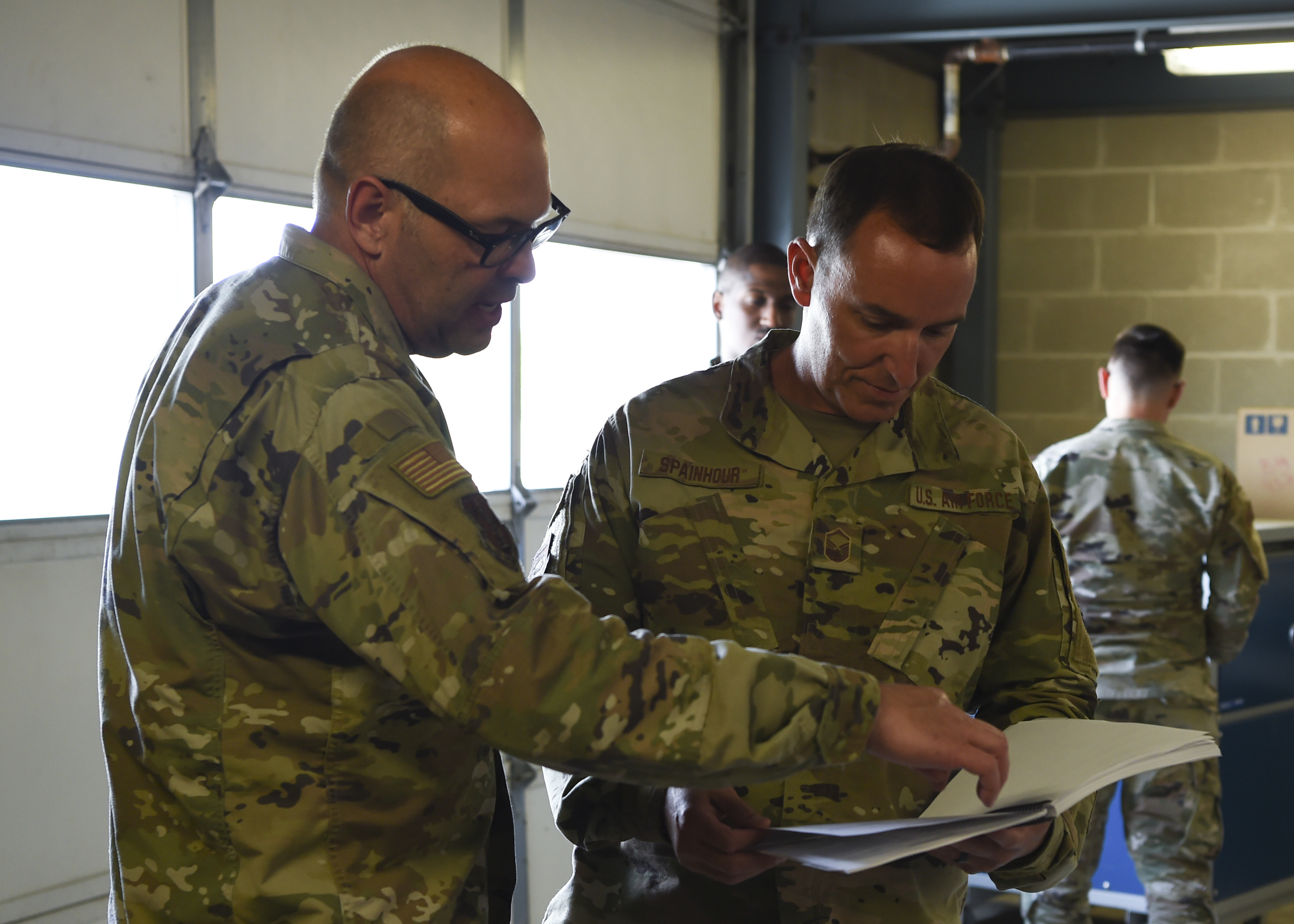 Airmen looking over form